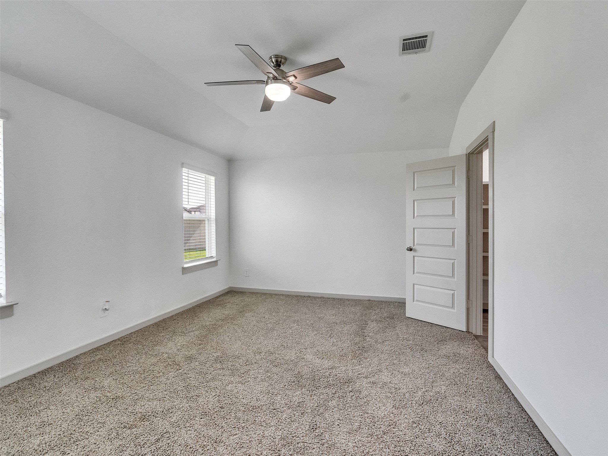 10627 Great Basin Drive Rosharon, TX 77583 - Photo 18 of 42 an empty room with windows and fan
