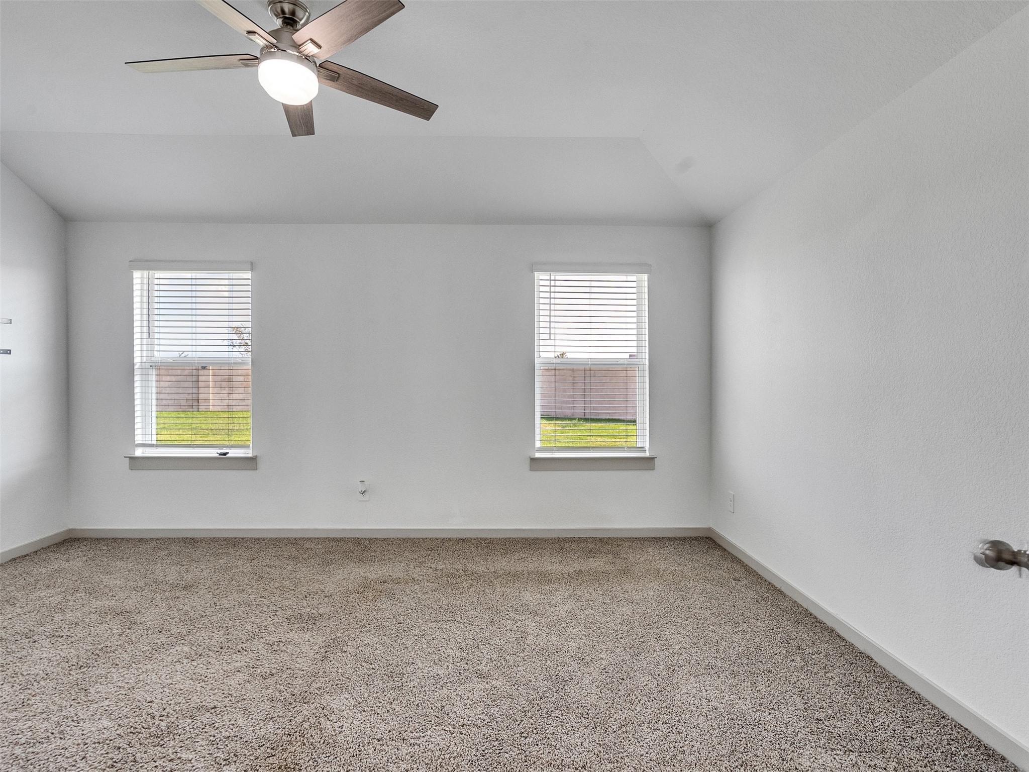 10627 Great Basin Drive Rosharon, TX 77583 - Photo 22 of 42 an empty room with windows and ceiling fan