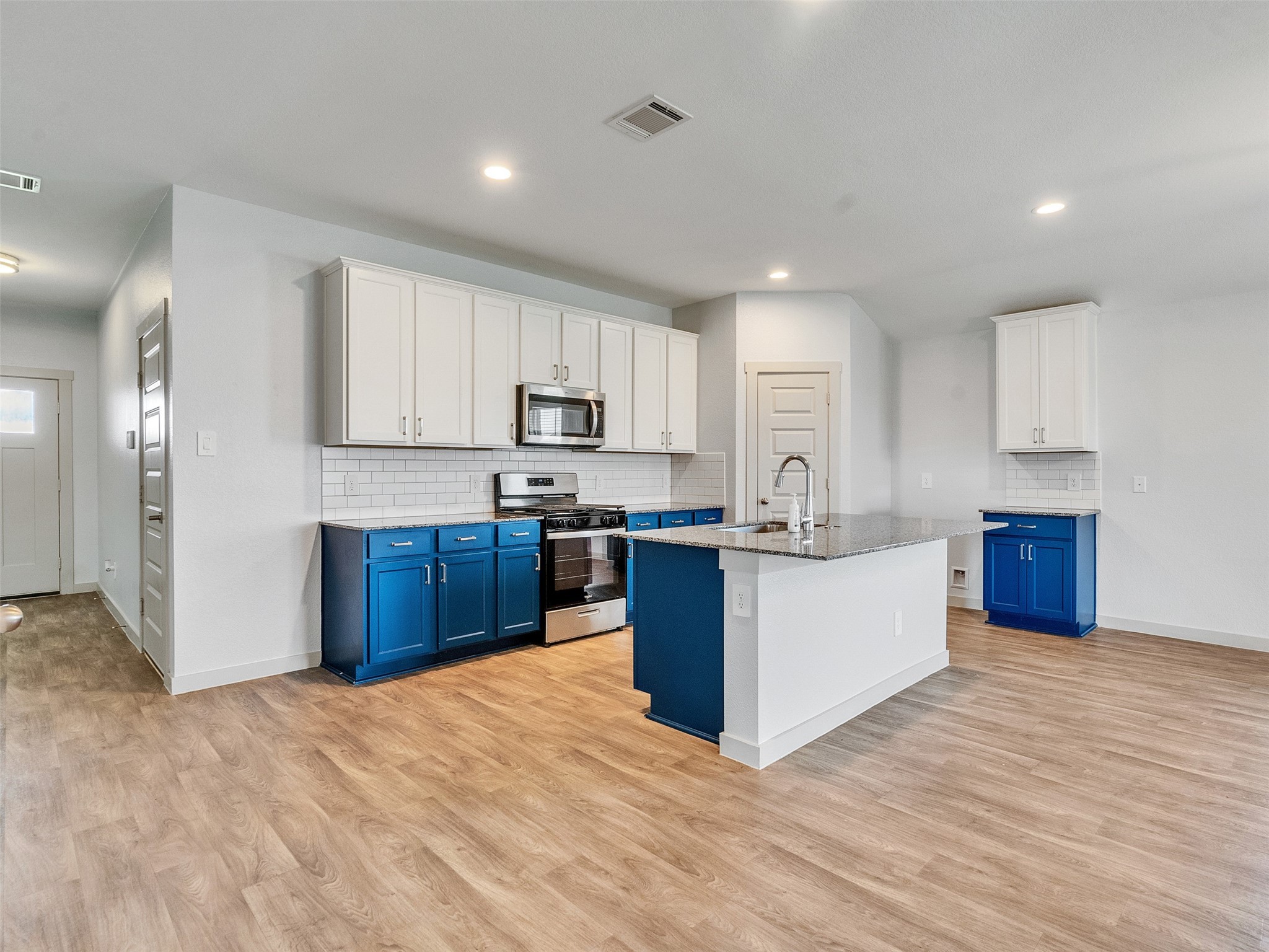 10627 Great Basin Drive Rosharon, TX 77583 - Photo 4 of 42 a kitchen with stainless steel appliances kitchen island granite countertop a refrigerator sink and cabinets