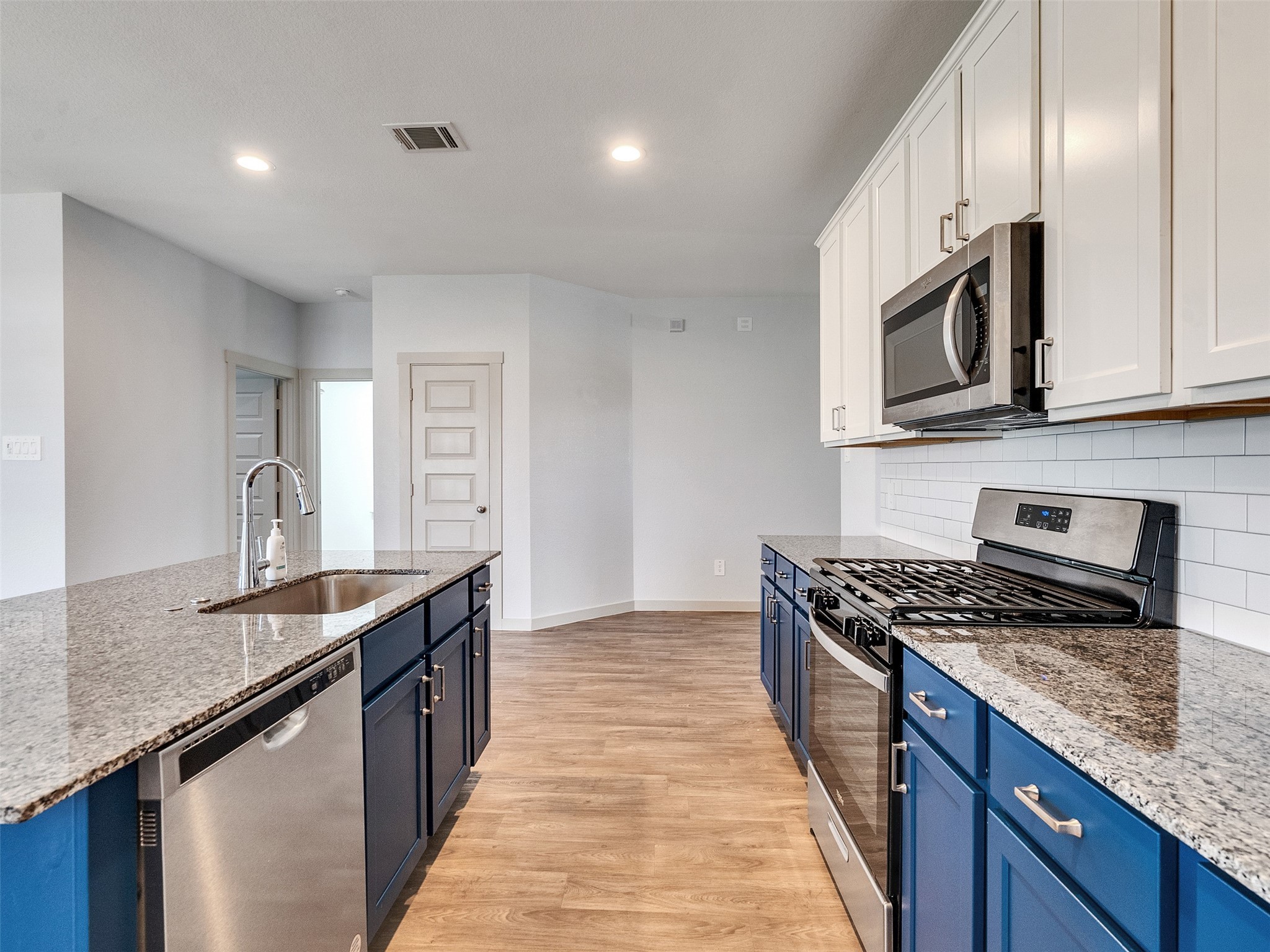 10627 Great Basin Drive Rosharon, TX 77583 - Photo 9 of 42 a kitchen with granite countertop stainless steel appliances a sink stove top oven and cabinets