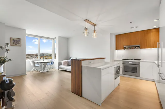 a kitchen with a stove and white cabinets