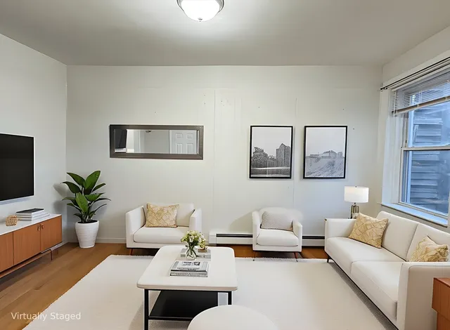 a living room with furniture and a potted plant on table