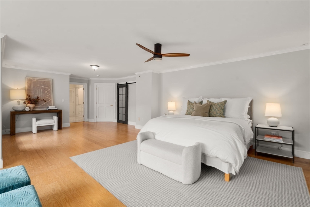 267 Dedham Street Dover, MA 02030 - Photo 23 of 35 a spacious bedroom with a bed and a chandelier