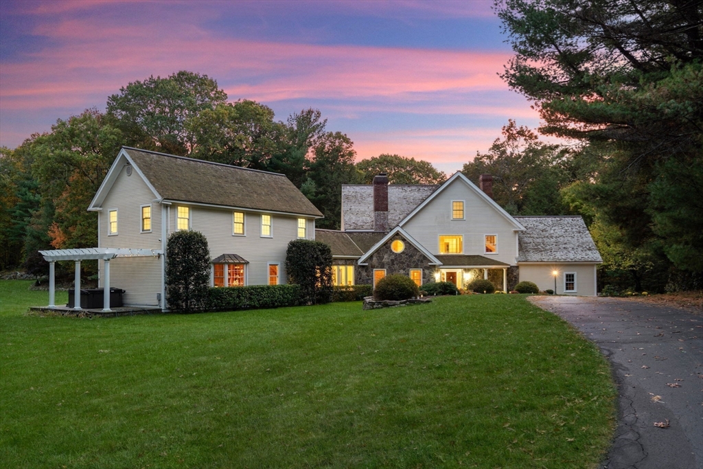 267 Dedham Street Dover, MA 02030 - Photo 3 of 35 a front view of a house with a garden