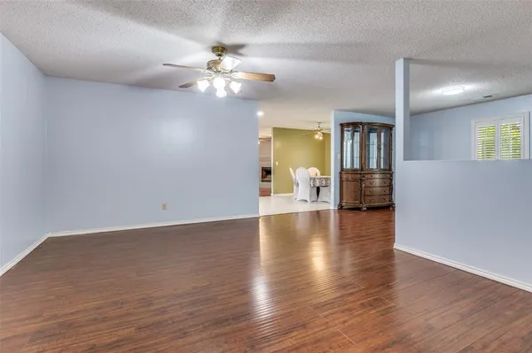 a view of livingroom with wooden floor and ceiling fan