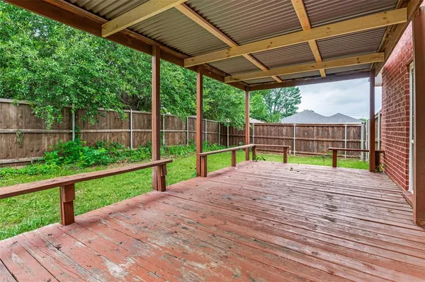 a view of a backyard with wooden floor and entertaining space