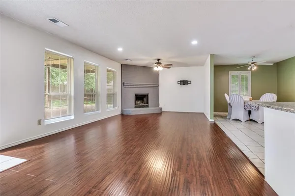 a view of a livingroom with furniture wooden floor and windows