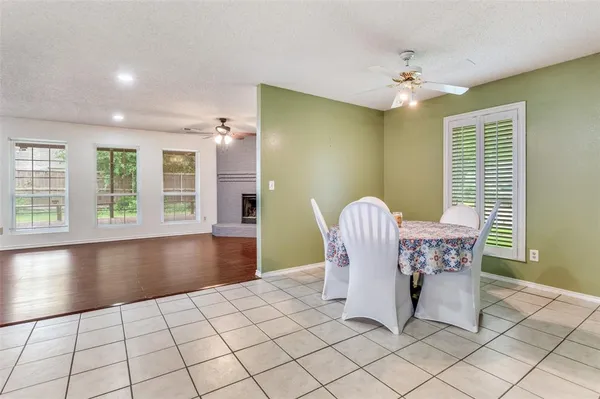 a view of a dining room with furniture and chandelier