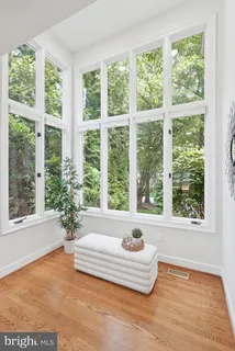 a living room with a large window and a table