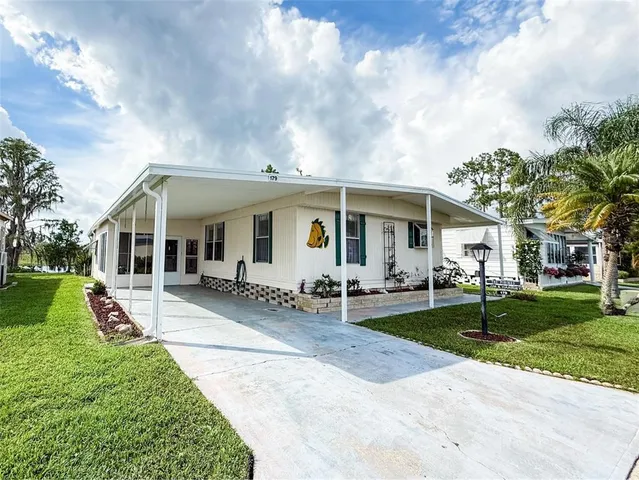 a view of a house with a yard and plants