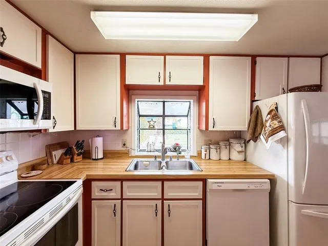 a kitchen with a sink and a refrigerator