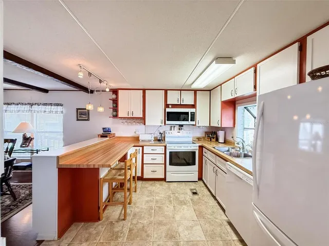 a large kitchen with cabinets and stainless steel appliances