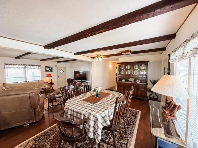 a view of a dining room with furniture wooden floor and chandelier