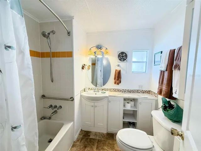 a kitchen with a sink a stove and cabinets