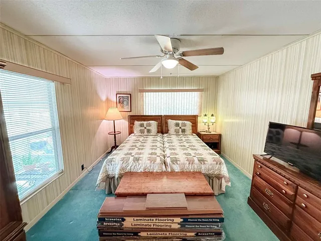 a bed room with a bed and a chandelier