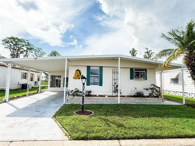 a view of a backyard with sitting area