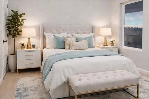 a bed room with a bed and a potted plant