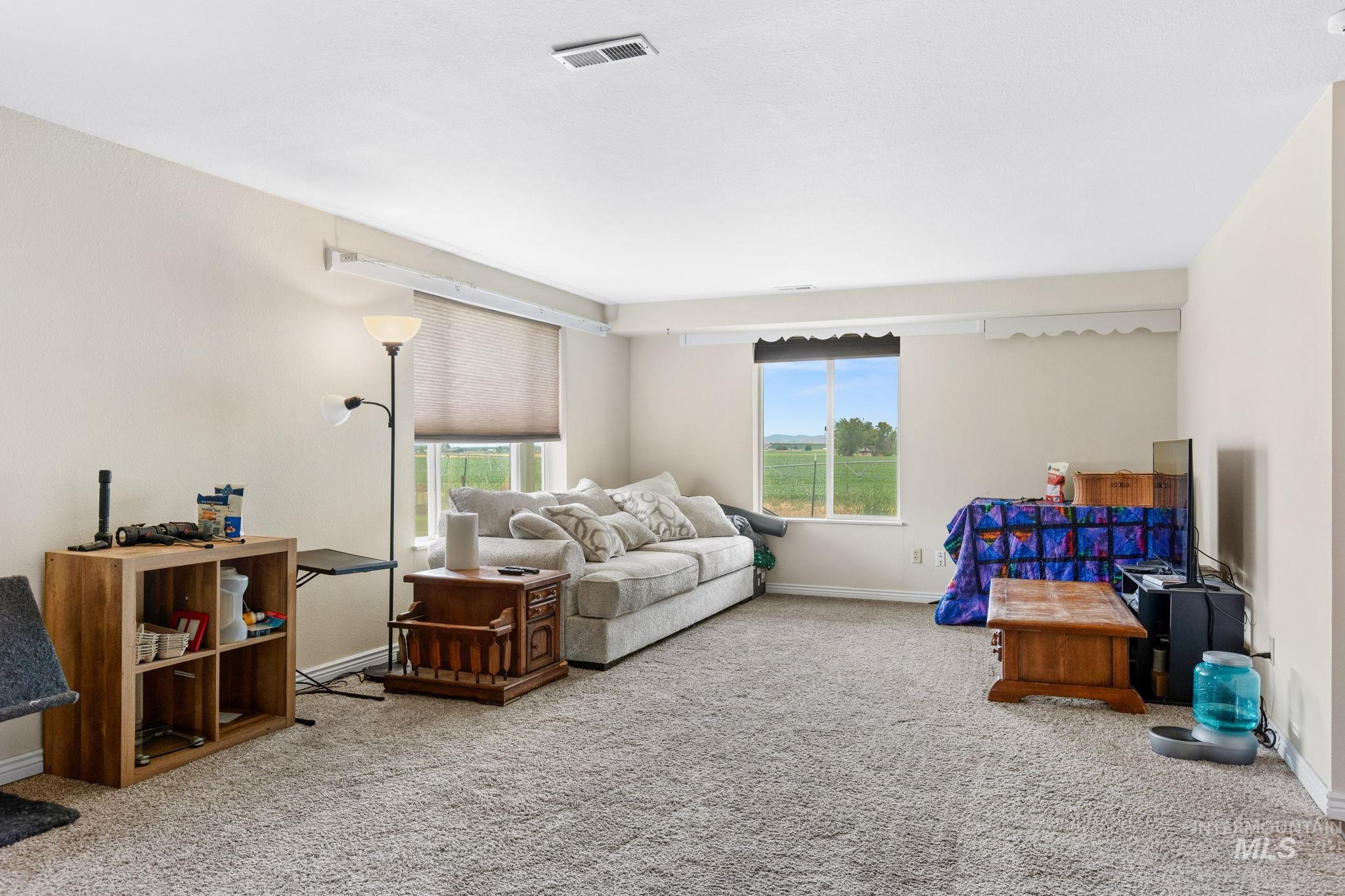18338 Pride Lane Caldwell, ID 83607 - Photo 5 of 50 Spacious room featuring neutral carpeting and light-colored walls