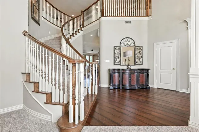 a dining room with furniture a chandelier and wooden floor