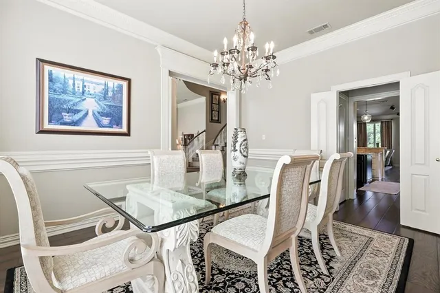 a hallway view with stainless steel appliances kitchen island wooden floors and center island