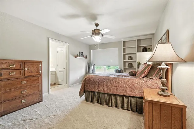 a bed room with a bed and a ceiling fan