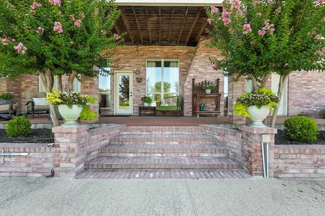 a front view of a house with potted plants