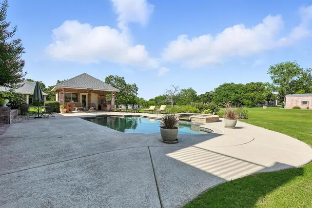 a front view of a house with a yard table and chairs