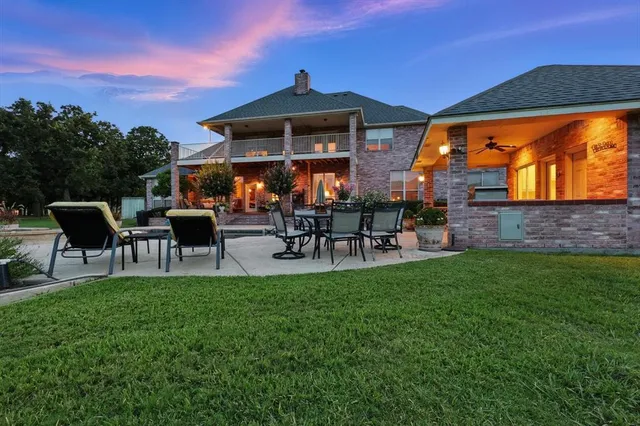 a view of a patio with a table chairs and a fire pit