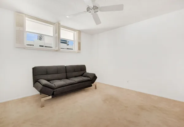 a living room with furniture and view of kitchen