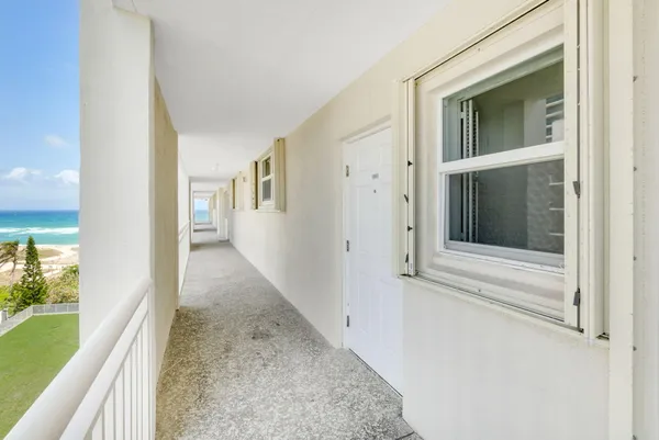 a room with pool table and window