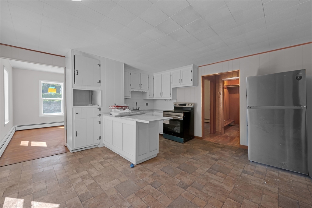 47 Morris Street Southbridge, MA 01550 - Photo 2 of 40 a kitchen with white cabinets and white appliances