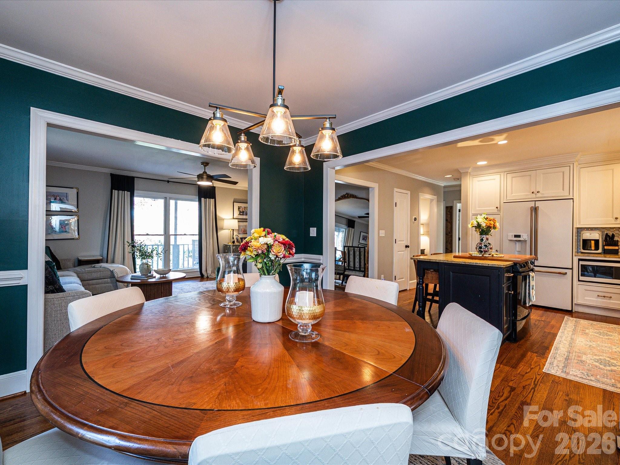 4540 Forest Cove Road Belmont, NC 28012 - Photo 12 of 46 a dining room with wooden floor a chandelier a wooden table and chairs