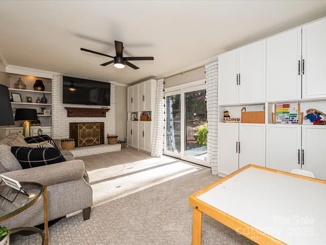 a living room with furniture a flat screen tv and a fireplace
