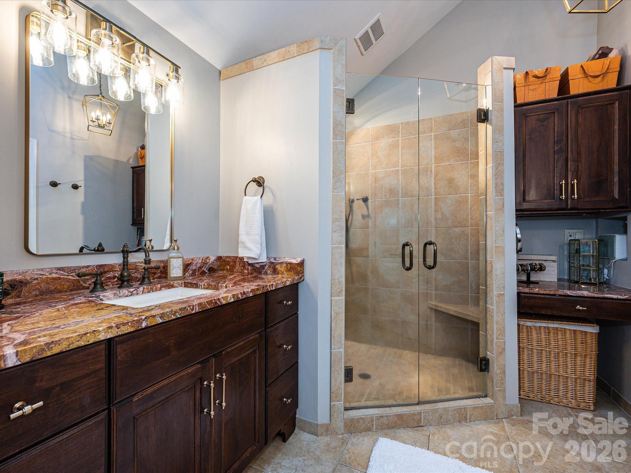 4540 Forest Cove Road Belmont, NC 28012 - Photo 20 of 46 a bathroom with a granite countertop sink a mirror and shower