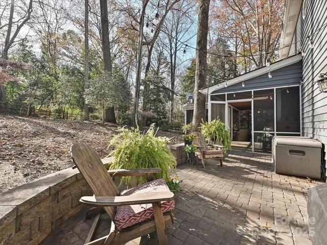 a view of backyard with outdoor seating and plants