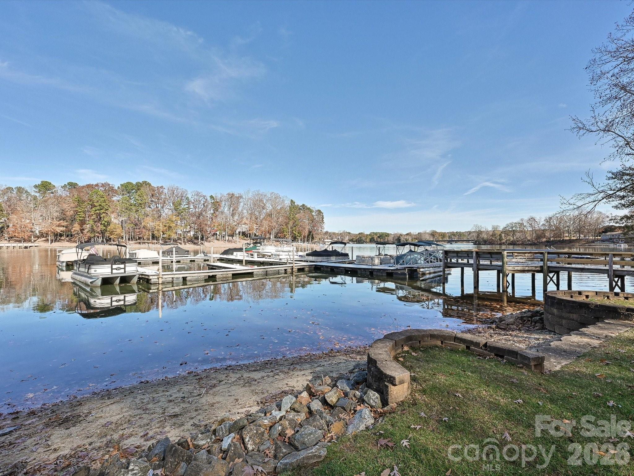 4540 Forest Cove Road Belmont, NC 28012 - Photo 40 of 46 a view of a lake with boats and trees in the background