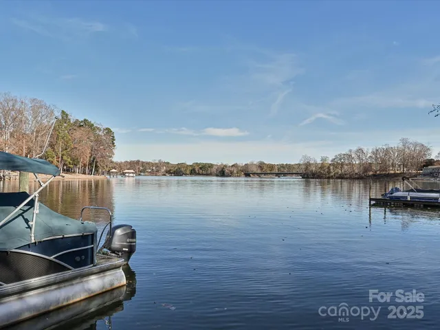 a view of a lake with couches chairs