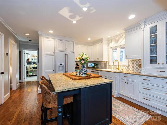 a kitchen with stainless steel appliances granite countertop wooden cabinets and a refrigerator