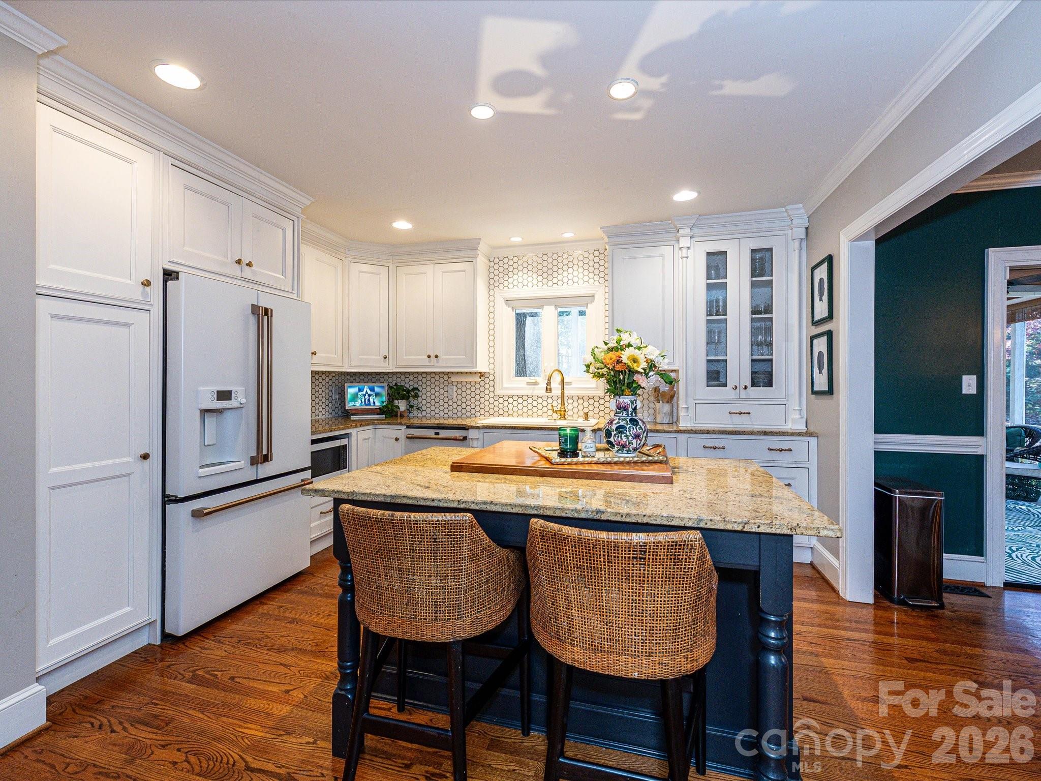 4540 Forest Cove Road Belmont, NC 28012 - Photo 7 of 46 a kitchen with granite countertop kitchen island stainless steel appliances a refrigerator a sink and a stove