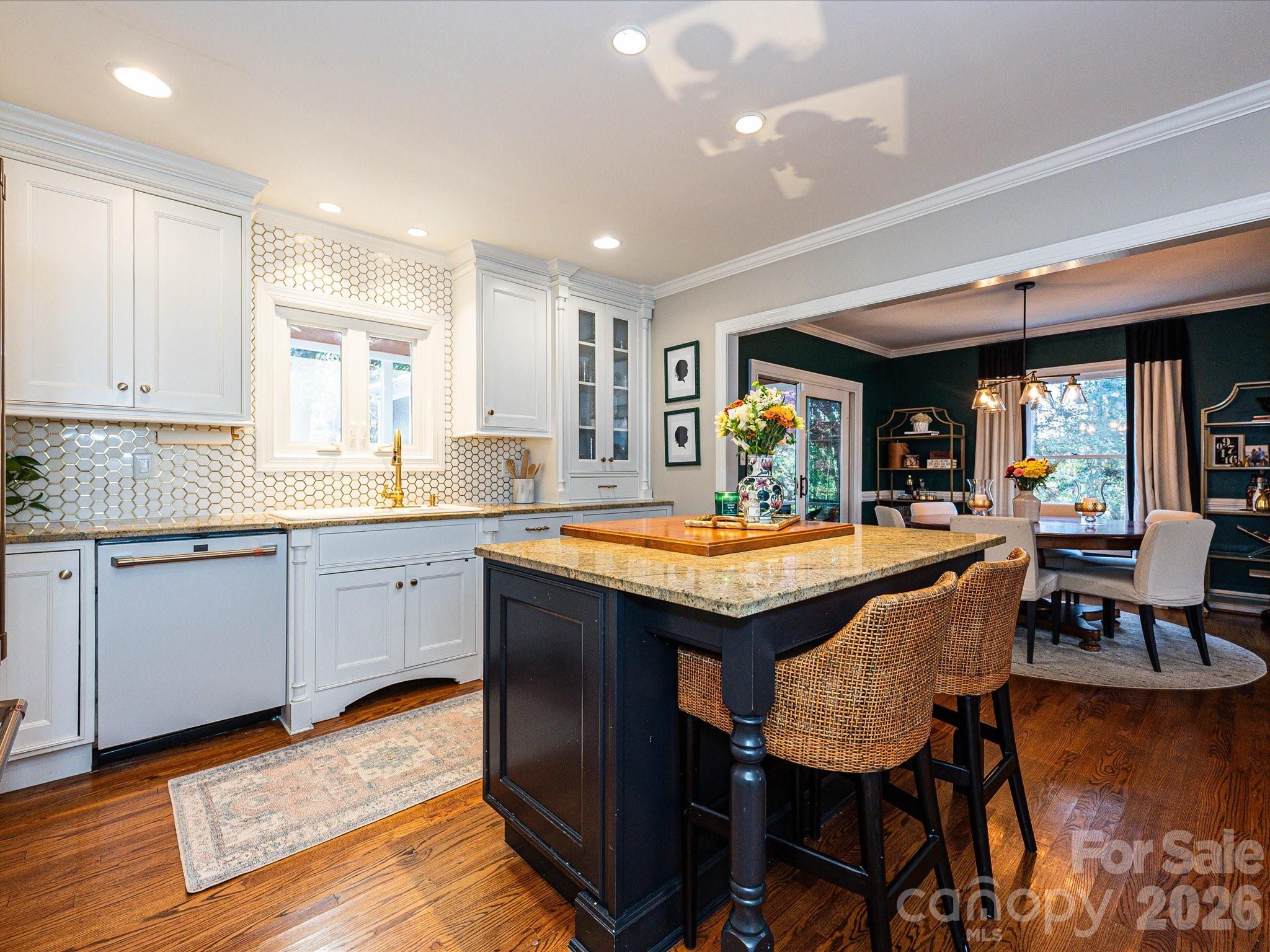 4540 Forest Cove Road Belmont, NC 28012 - Photo 8 of 46 a kitchen with granite countertop a table chairs sink and wooden floor