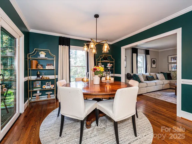 a dining room with furniture a rug and wooden floor