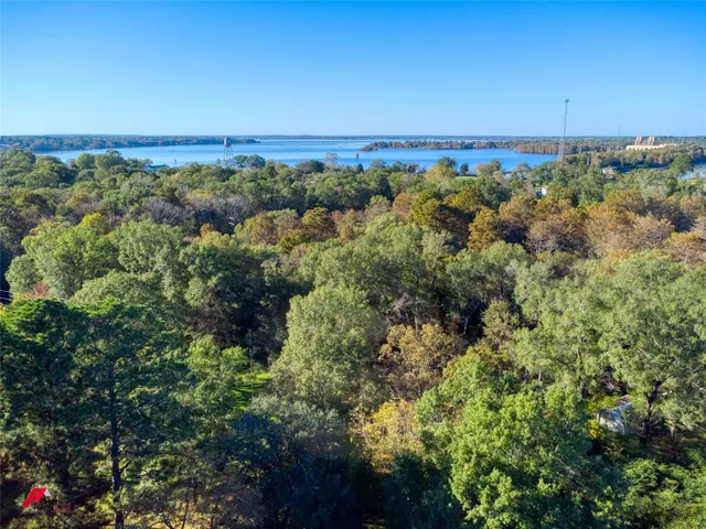 an aerial view of a city with lots of residential buildings and mountain in the background