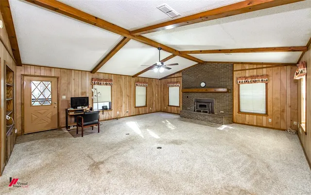 a view of a livingroom with furniture and a fireplace