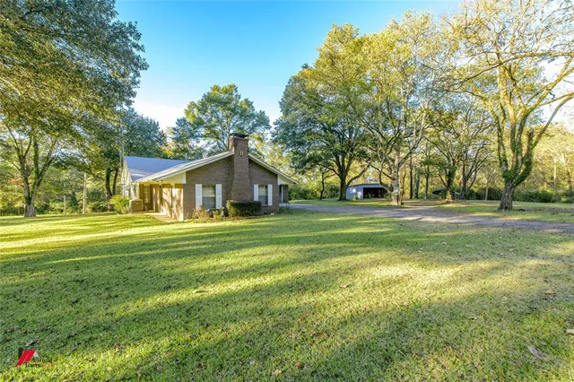 a front view of a house with a big yard