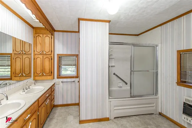 a bathroom with a tub a sink and mirrors