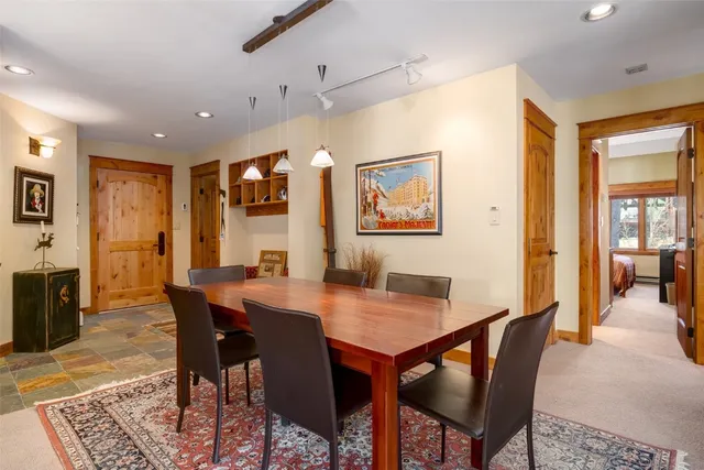 a bedroom with a bed and a dresser next to a window