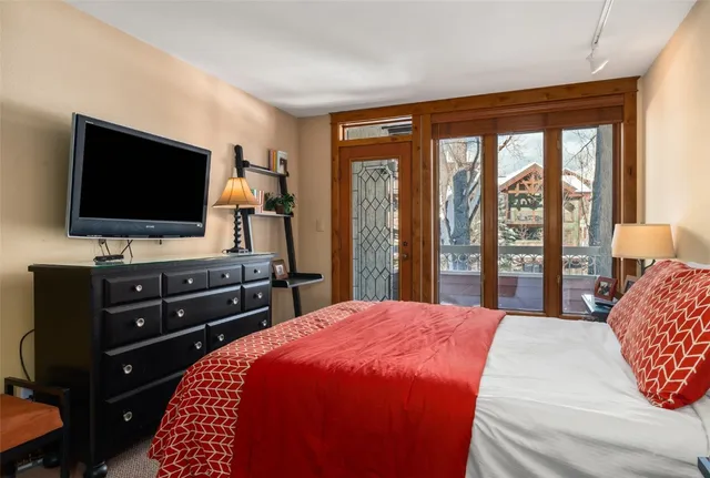 a bedroom with a bed and a lamp