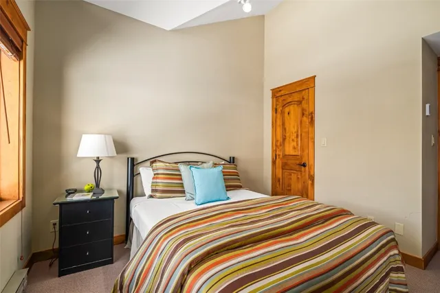 a bathroom with a granite countertop toilet sink and mirror