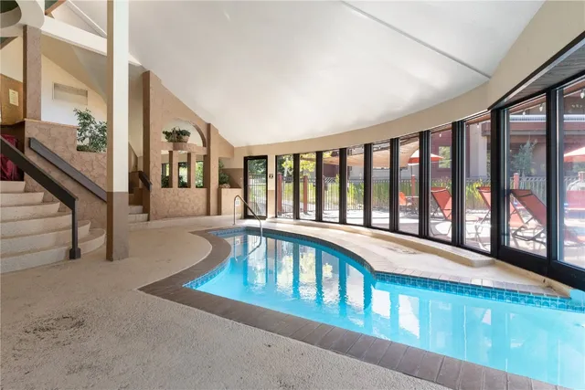 a kitchen with kitchen island a dining table chairs sink and cabinets