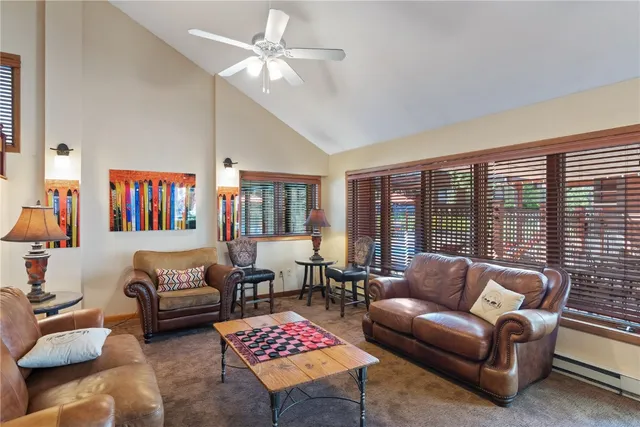 a view of a dining room with furniture and a chandelier